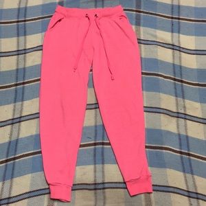 Neon pink joggers with strings to adjust the waist